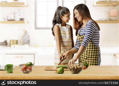 Mother and daughter cutting vegetables