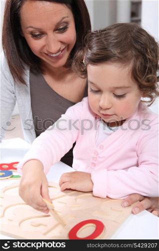 Mother and daughter doing a wooden