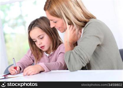 Mother and daughter doing homework at home