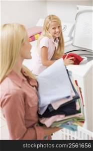 Mother And Daughter Doing Laundry