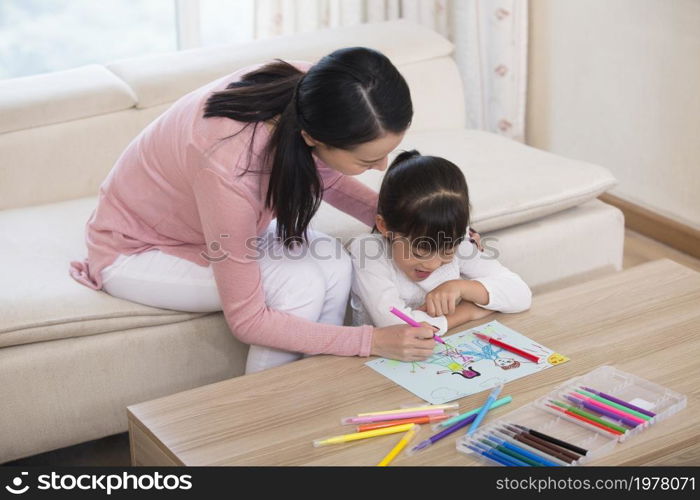 Mother and daughter drawing pictures together