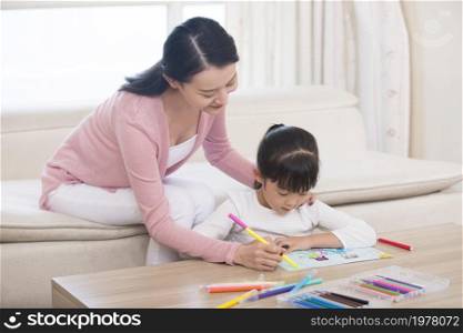 Mother and daughter drawing pictures together