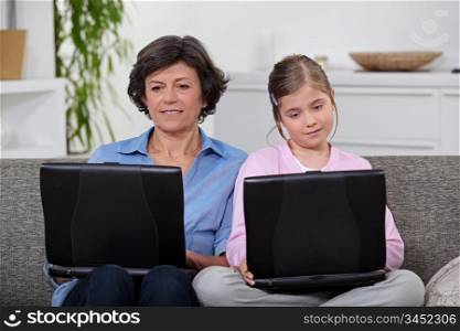 Mother and daughter each with their own laptop