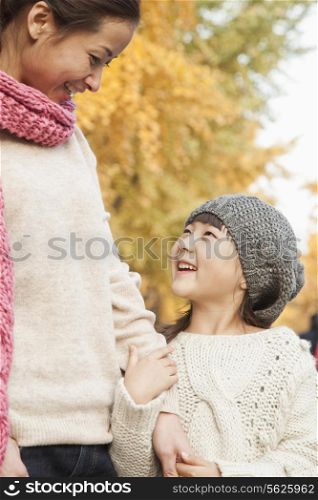Mother and Daughter Enjoying a Park in Autumn