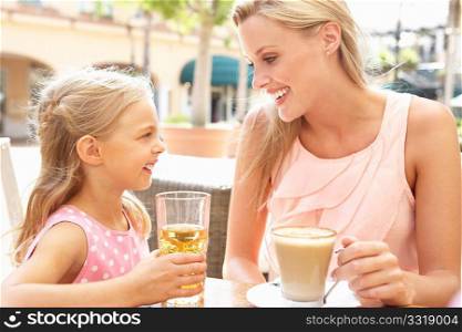 Mother And Daughter Enjoying Cup Of Coffee And Juice In CafZ Together