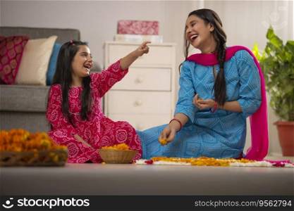 Mother and daughter enjoying together during house decoration 