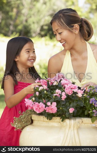 Mother And Daughter Gardening Together