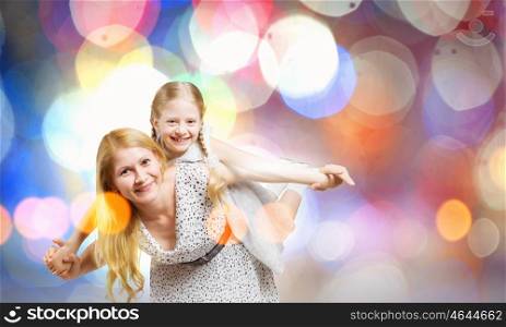 Mother and daughter. Happy family of mother and daughter against bokeh background