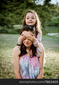 Mother and daughter having a great fun in the summer park