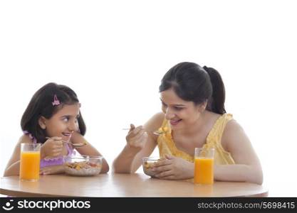 Mother and daughter having breakfast