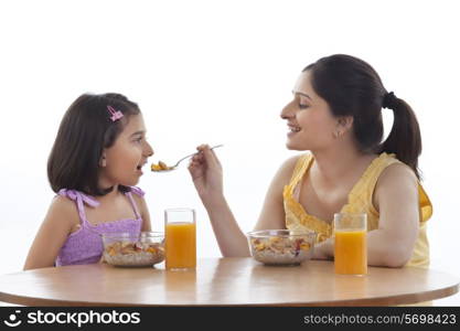 Mother and daughter having breakfast