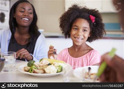 Mother And Daughter Having Family Meal At Table