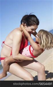 Mother And Daughter Having Fun On Beach