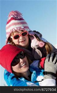 Mother And Daughter Having Fun On Ski Holiday In Mountains