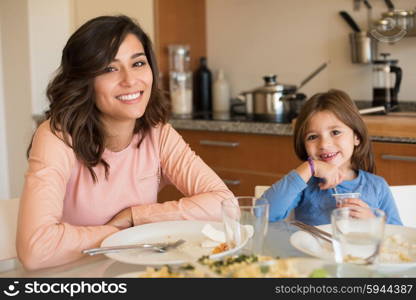 Mother and daughter having lunch in the kitchen