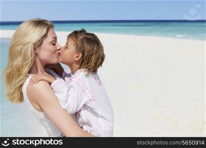 Mother And Daughter Hugging On Beautiful Beach