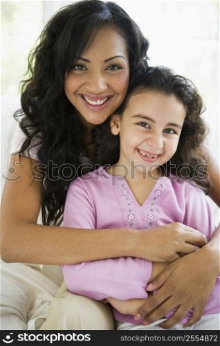 Mother and daughter in living room smiling (high key)