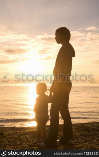 Mother and daughter in sunset