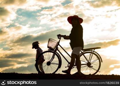 Mother and daughter in the countryside at sunset