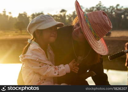 Mother and daughter in the countryside at sunset