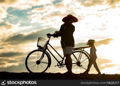Mother and daughter in the countryside at sunset