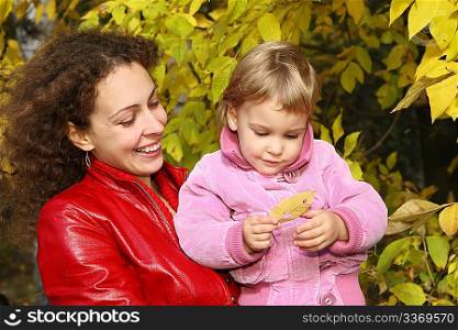 mother and daughter in the park in autumn 2