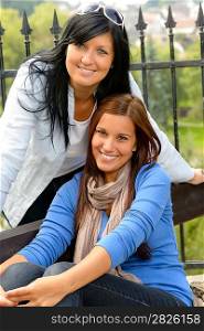 Mother and daughter in the park smiling teen together loving