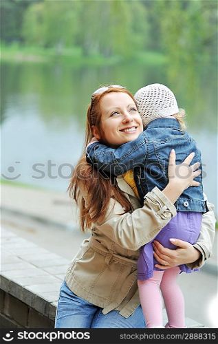 Mother and daughter in the spring park