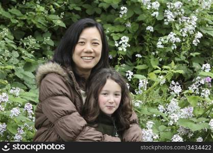 Mother and daughter in white flower field