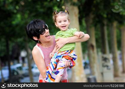 Mother and daughter laughing in the park