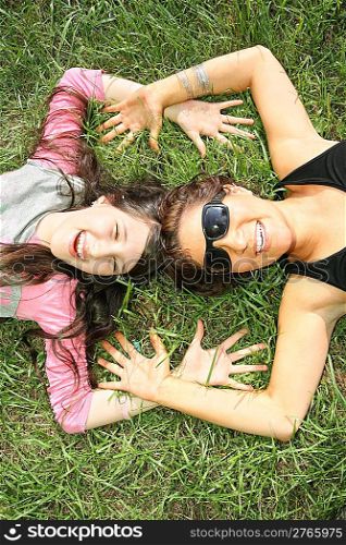 mother and daughter lie on the grass 2