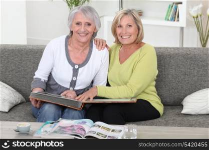 Mother and daughter looking at a picture album together