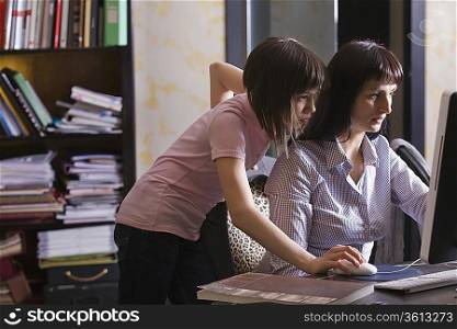 Mother and daughter looking at computer screen