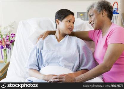 Mother And Daughter Looking At Each Other In Hospital