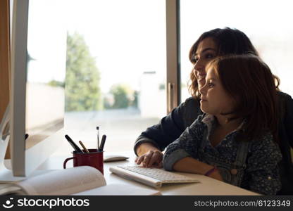 Mother and daughter looking to the computer