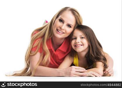 Mother and daughter lying on the floor. Mother and daughter lying on the floor isolated on white background