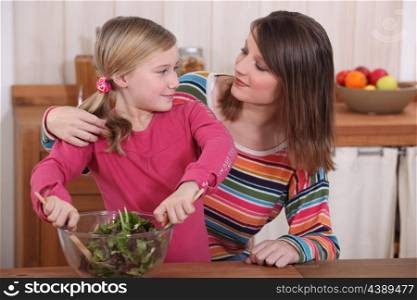mother and daughter making a salad