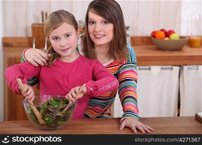 Mother and daughter making salad