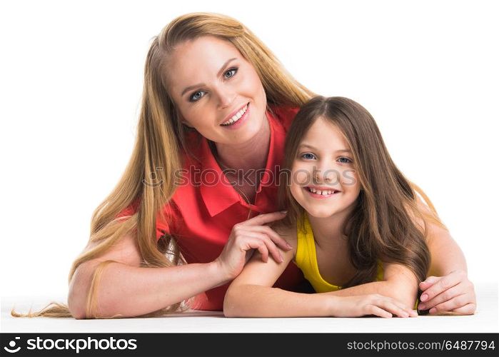Mother and daughter. Mother and daughter lying on the floor, isolated on white background
