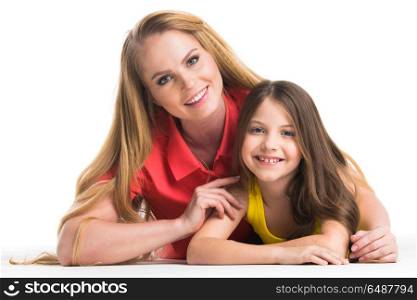 Mother and daughter. Mother and daughter lying on the floor, isolated on white background