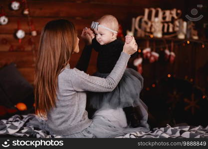 mother and daughter on background of New Year’s decorations. New Year and Christmas. selective focus.. mother and daughter on background of New Year’s decorations. New Year and Christmas. selective focus