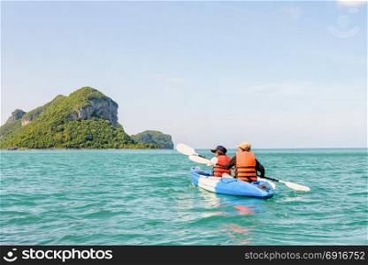 Mother and daughter on kayak. Two women are mother and daughter. Travel by boat with a kayak happy under the blue sky summer around Ko Phi view the beautiful nature of the sea and island, Mu Ko Ang Thong National Park, Surat Thani, Thailand