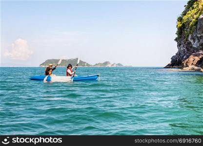 Mother and daughter on kayak. Two women are mother and daughter. Travel by boat with a kayak happy under the blue sky summer around Ko Phi view the beautiful nature of the sea and island, Mu Ko Ang Thong National Park, Surat Thani, Thailand