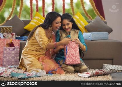 Mother and daughter packing gifts together