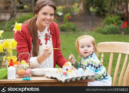 Mother And Daughter Painting Easter Eggs In Gardens