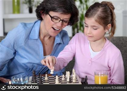 Mother and daughter playing chess