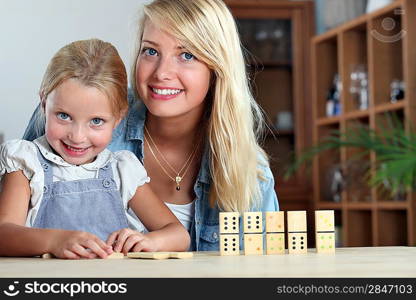 Mother and daughter playing dominoes