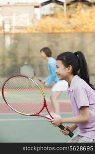 Mother and daughter playing tennis