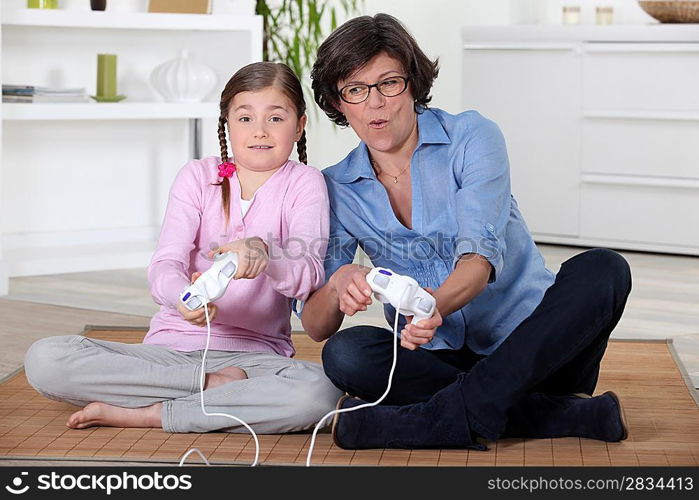 Mother and daughter playing video games