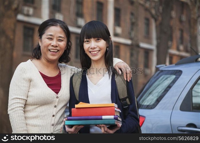 Mother and daughter portrait in front of dormitory